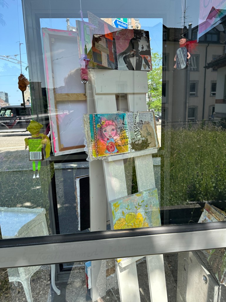 Mixed media journals and small artworks inside the phone booth