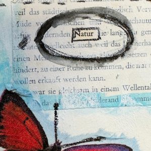 Close-up of a mixed media art journal page with the word “Natur” circled and a red butterfly wing.