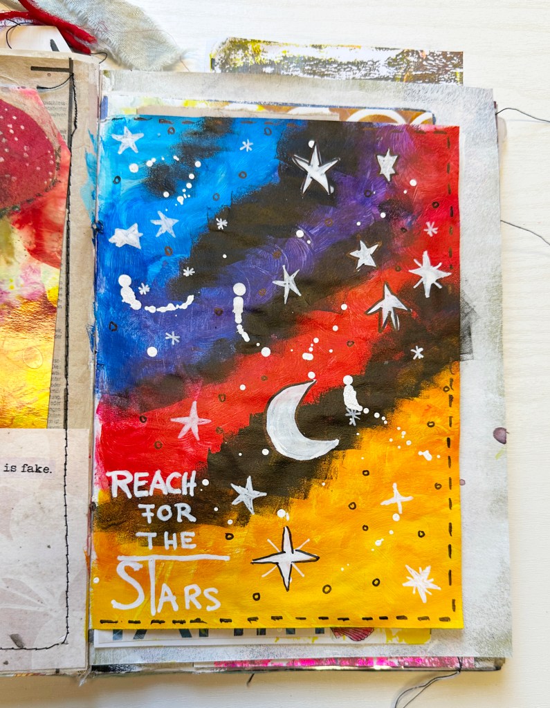 A spontaneous mixed media art journal page using recycled paper, acrylic paint, and Posca pen. Learn how Bea Grob transformed a simple catalog page into a colorful galaxy — no brush needed!