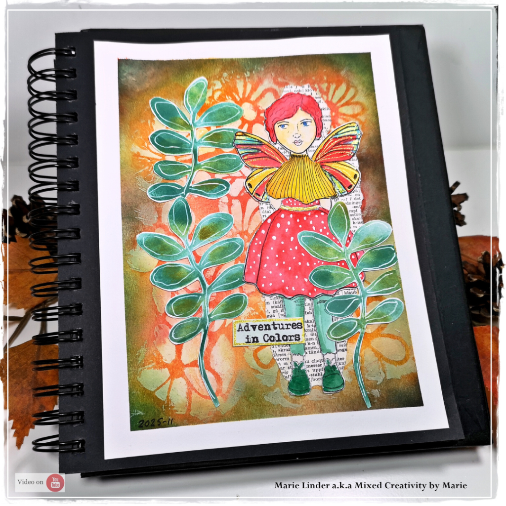 Hands stamping and coloring paper cutouts using the Little Stories stamp set from Bea Grob’s Mix • Match • Create collection. The finished art journal page shows an “Autumn Girl” with butterfly wings, surrounded by bright leaves in warm fall colors, created by Design Team member Marie Linder (@mixedcreativitybymarie).