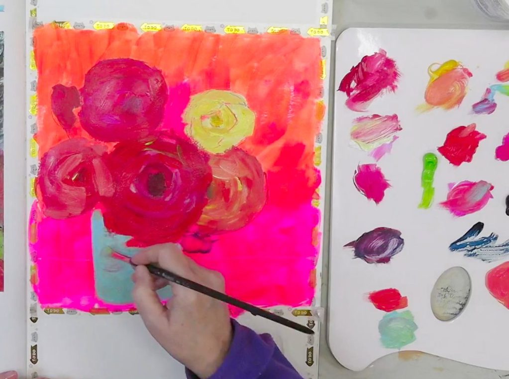 A colorful mixed media painting process featuring a bold flower bouquet on a fluorescent pink and orange background in an art journal.