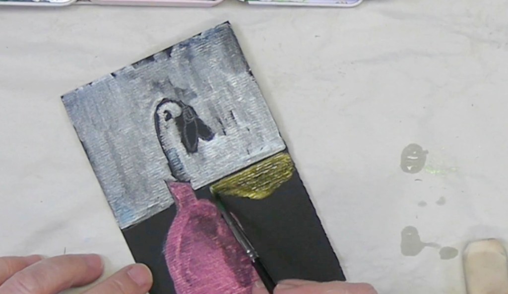 An artist's hand is painting a colorful illustration featuring a pink vase and a bird against a textured gray background.