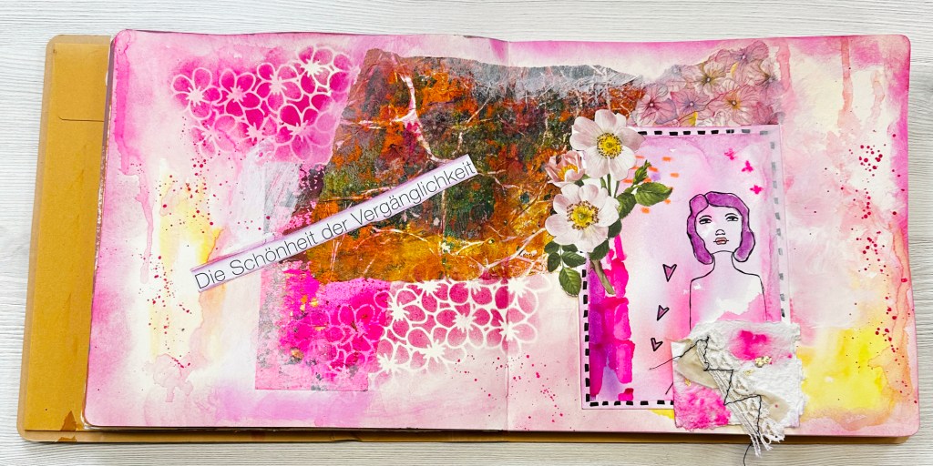An artistic mixed media journal page featuring a vibrant pink background, with abstract patterns, floral elements, and a hand-drawn figure. The page includes the text 'Die Schönheit der Vergänglichkeit' across the top.