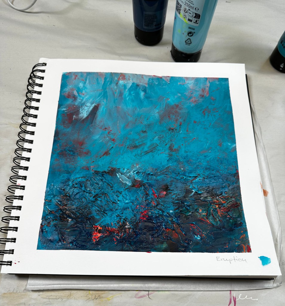 An abstract painting titled 'Eruption' featuring vibrant shades of blue with textured layers and hints of red and dark colors, displayed on a spiral-bound sketchbook.